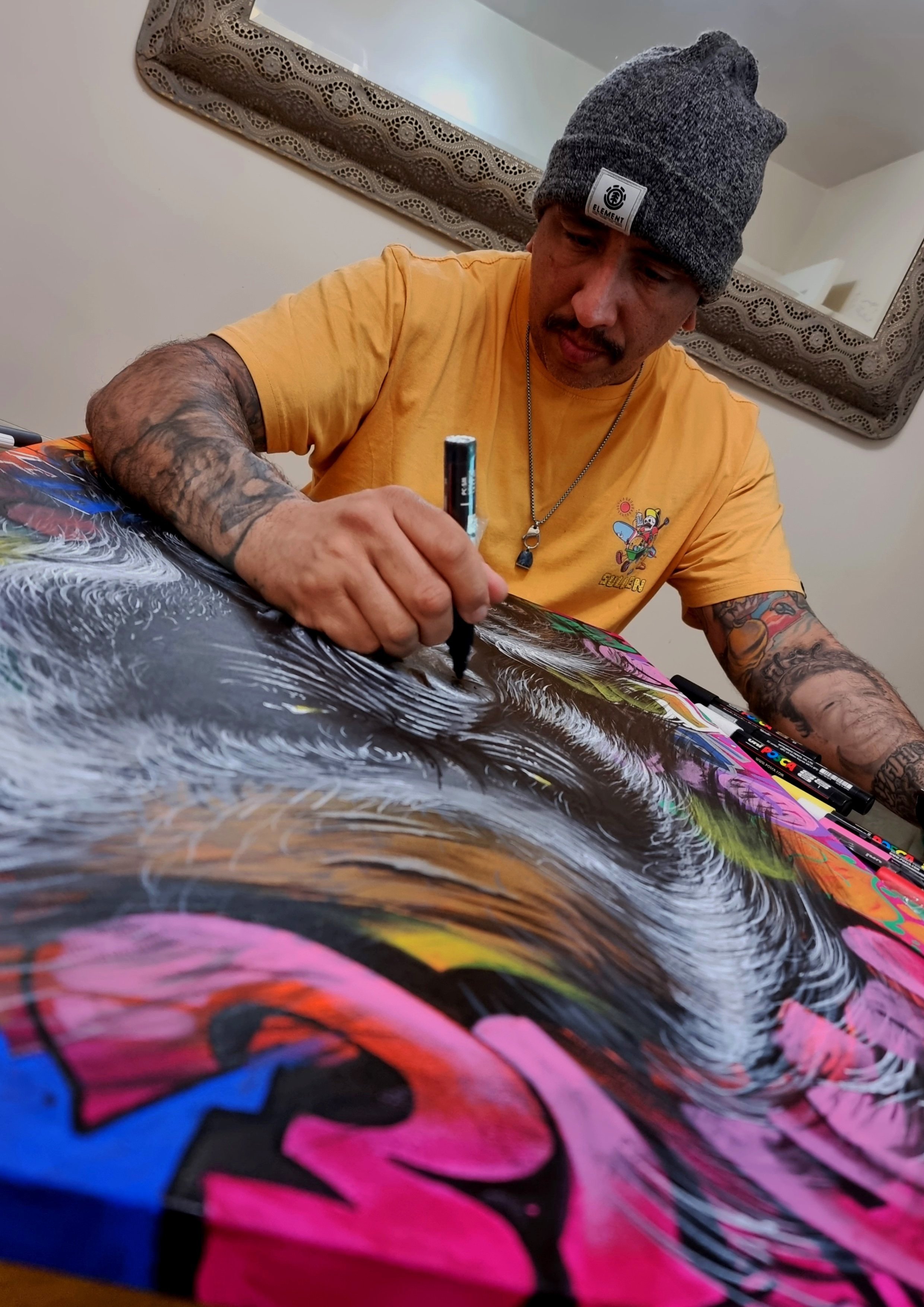 André Fila painting a large artwork